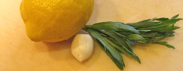 A lemon, clove of garlic and a few springs of tarragon
