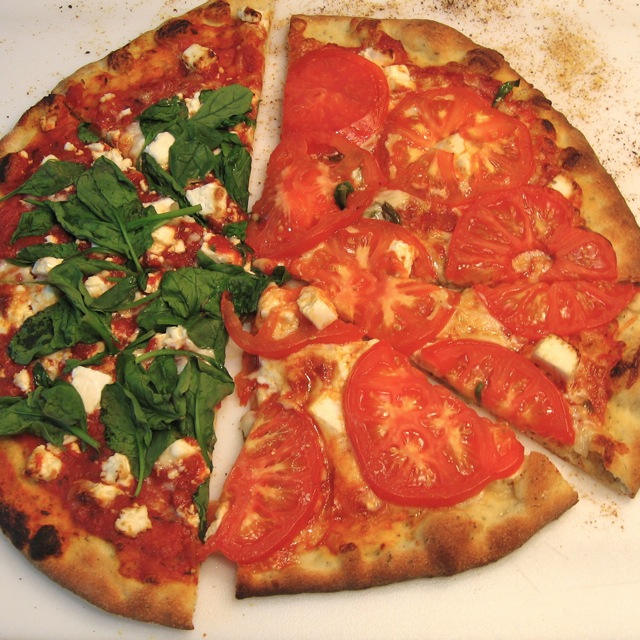 Some of each Half Spinach and Feta and Half Tomato Pizza sliced