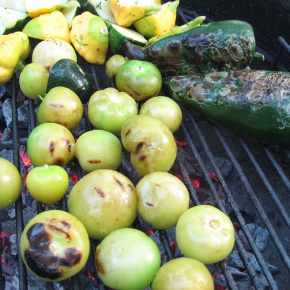 Tomatillos are almost done, peppers in the back and charing nicely.  Squash behind that.
